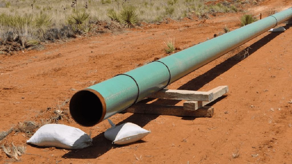 an open pipeline on brown dirt